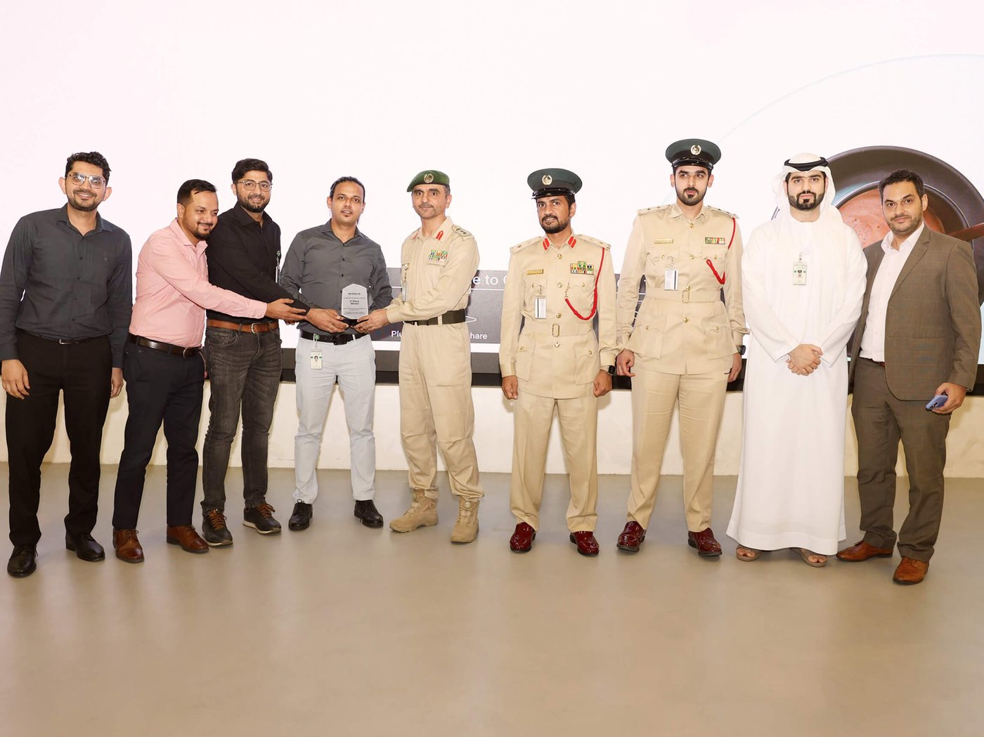 Ramesh's team receiving the ServiceNow Hackathon third-place trophy from Dubai Police officers
